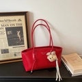 Macro dettagliata di una borsa tote vintage in pelle verniciata rossa con ciondolo orso - Rosso con Pendente