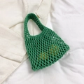Green handmade woven hollow net tote bag shown with lemons for capacity display - Green