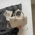 Creamy white matte PU leather Boston handbag with embossed logo and gold hardware details - Off White