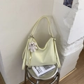 Detailed side view of cream yellow PU leather tote bag with a cute white plush bear pendant - Yellow with Pendant