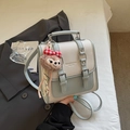 Litchi pattern leather crossbody bag in blue and white contrast with plush charm - Blue with Charm