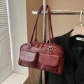 Burgundy PU leather handbag with geometric pattern and golden hardware hanging on rack - Red Patchwork