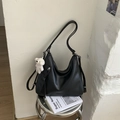 Détail du sac hobo en similicuir noir avec fermeture à franges et breloque ourson - Noir Avec Pendentif