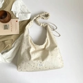 Chic cream canvas tote bag with silver star patterns and ruched cloud-style shoulder strap - Off White