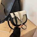 Detailed close-up of a color-block saddle bag featuring olive green fabric and cream leather - Khaki