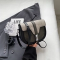 Detail of a vintage saddle bag with silver metal twist lock and mixed fabric texture - Black