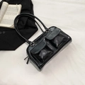 Minimalist black glossy faux leather shoulder bag with double pockets and long strap - Black