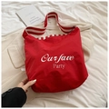 Red canvas tote bag with white typography and striped shoulder strap for casual daily use - Red
