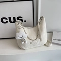 Quilted hobo shoulder bag in cream white with silver chain and plush smiley charm - Beige (With Pendant)