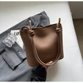 Brown leather bucket bag with unique knotted shoulder strap and elegant gold metal ends - Brown