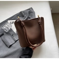 Brown lychee pattern bucket bag with unique knot handle and leather fashion slogan - Brown