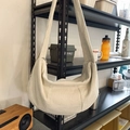 Off-white corduroy crescent shoulder bag with a wide strap and silver zipper detail - White