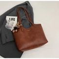 Detail of retro brown leather tote bag with gold logo and plush rabbit pendant accessory - With Pendant / Brown