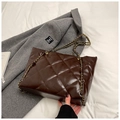 Quilted dark brown tote bag with gold chain strap on a grey coat background - No Pendant / Brown