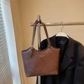 Retro brown leather tote bag with gold lettering hanging on a metal rack - No Pendant / Brown