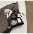 Glossy black faux leather pillow bag with dual handles and detachable slim strap - Black