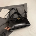 Classic black briefcase-style handbag with golden hardware and adjustable strap - Black without Pendant