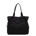Minimalist black canvas tote bag with side drawstring pockets and silver button closure - Black