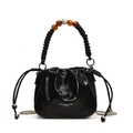 Black quilted drawstring bucket bag with a spiral handle and unique amber bead accents - Black