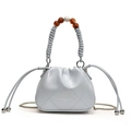 Quilted light blue drawstring bucket bag with chain strap and beaded handle accents - Light Blue