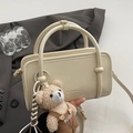 Minimalist cream leather crossbody bag with metal ring handle and plush bear pendant - White With Overalls Bear