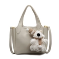 Minimalist beige litchi grain leather bucket bag with a cute plush bear charm accessory - Off White With Dog Charm