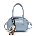 Light blue bowling style crossbody bag with smooth glossy finish and cartoon charm - Blue