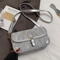 Chic silver crossbody bag with pleated texture and golden buckle on a grey blazer - Silver - No Charm