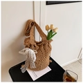 Detail of hand-woven straw bucket bag with hollow pattern and lace bow accessory - With Lace Bow And Pearl Pendant / Khaki With Pendant