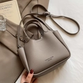 Taupe lychee pattern leather bucket bag with top handle and crossbody strap design - Gray