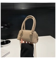 Detail of beige textured leather shell bag showing double handles and gold bead chain strap - Khaki