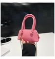 Detail of pink shell bag featuring lychee grain leather and golden ball chain strap - Pink