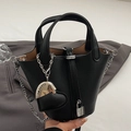 Black lychee textured bucket bag with silver lock and heart charm accessory - Black With Heart Charm