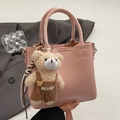 Pink faux leather bucket handbag with cute plush bear charm for a stylish commute look - With Pendant / Pink