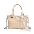 Beige straw bucket bag with white lace bow detail and metallic chain shoulder strap - White
