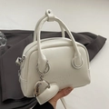 Elegant white oil wax leather bowling bag with heart charm and silver zipper detail - Off-White (With Heart Charm)
