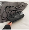 Detail of glossy black leather boston bag with white logo and adjustable shoulder strap - Black