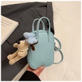 Detail of light blue lychee pattern leather handbag with cute dog plush pendant charm - Blue with Pendant