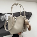Minimalist cream white lychee leather bucket bag with a cute bear charm and adjustable strap - White With Bear Charm