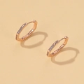 Octagonal rose gold hoop earrings with white zircon stones on light beige background - Large Geometric Rose Gold (3765)