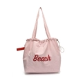 Light pink drawstring tote bag with red Beach lettering and lightweight nylon texture - Pink