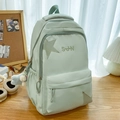 Sac à dos scolaire vert menthe avec broderie étoile et peluche sur un bureau - Avec Pendentif Étoile en Peluche / Vert