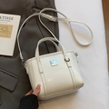 Minimalist white glossy leather bucket bag with silver metal logo and adjustable strap - No Pendant / Off White