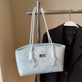 Light blue tote bag with embossed cartoon bear and rabbit patterns on leather surface - Blue