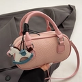 Pink lychee texture leather barrel handbag with horse charm and dual round handles - Pink + PU Horse