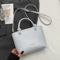 Elegant light blue bucket bag with gold branding and adjustable shoulder strap - No Pendant / Blue