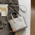 Silver woven texture bucket bag with metal logo and adjustable strap in lifestyle setting - No Pendant / Silver