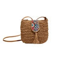 Ethnic straw crossbody bag featuring colorful beadwork and long tassels on white background - Khaki