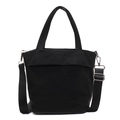 Minimalist black canvas handbag with thick round handles and adjustable shoulder strap - Black
