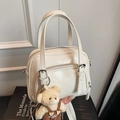 Chic milky white oil wax leather pillow bag with cute plush bear charm for daily wear - Off-white With Bear Charm